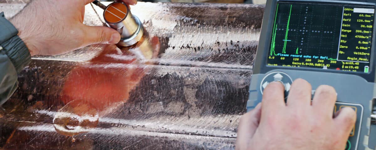 Level 2 inspector is testing to copper casting material with ultrasonic testing device. Ultrasonic Testing (UT) uses high frequency sound energy to conduct examinations and make measurements.